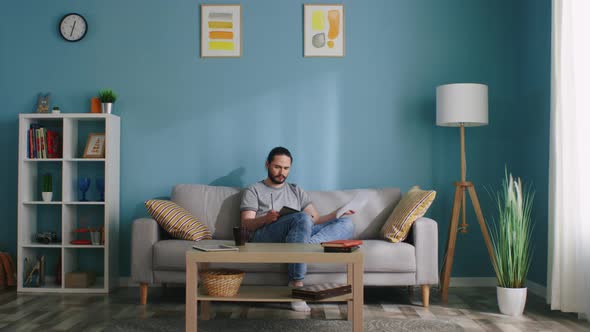 Man Tears a Sheet of Paper Out alt
