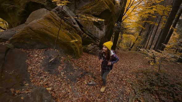 Slow Motion Wide Angle View Girl Traveler Hikes in Woods with Yellow Foliage in Ukraine alt