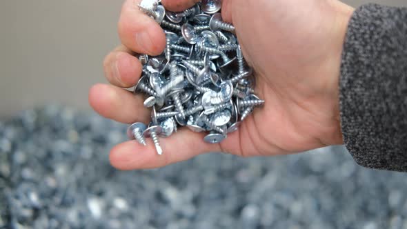 Close Up of Man Choosing Self Tapping Screws alt