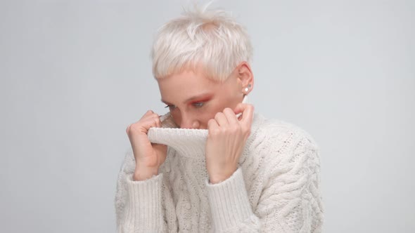 Blond Woman with Short Haircut Wears Knitted Sweater