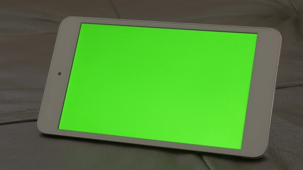 Modern silver and white tablet computer green screen display panning 4K 2160p 30fps UltraHD footage  alt