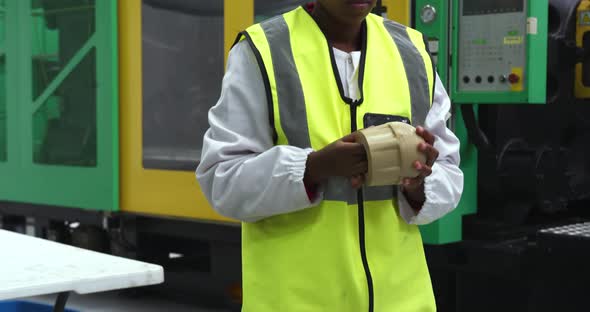 Warehouse female worker working in factory alt