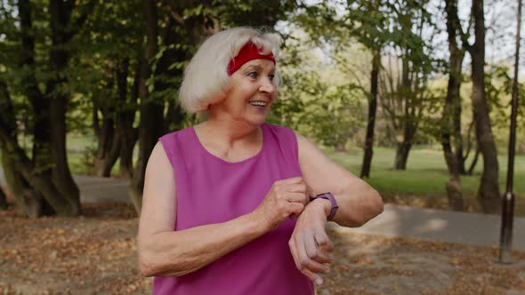 Senior Sport Runner Woman Using Smart Watch, Tracking Distance, Checking Pulse After Fitness Workout alt