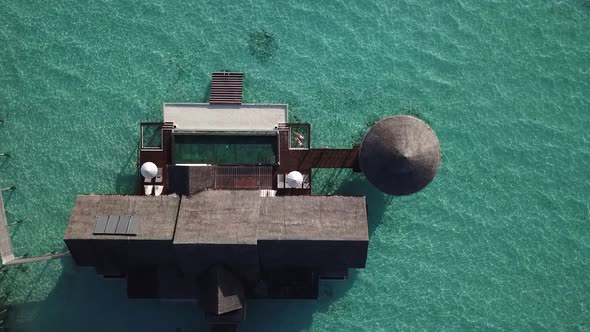 Huge water villa at the Maldives resort in the middle of the ocean. view from above. 4K alt