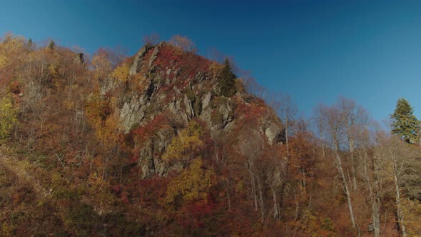 Forested Rock of Caucasian Mountain Range Painted in Autumn Colours