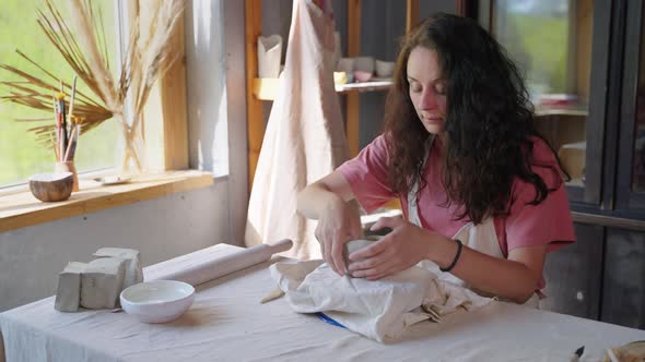 Art Hobby of Talented Woman in Workshop Female Artist is Modeling From Clay alt