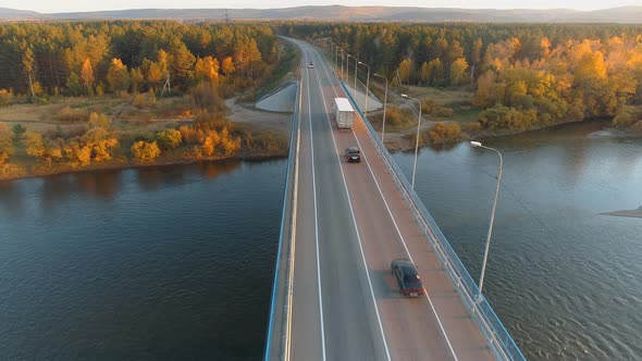 Aerial Top View of Business Bridge Over River, Autumn Landscape with Highway Road and Car