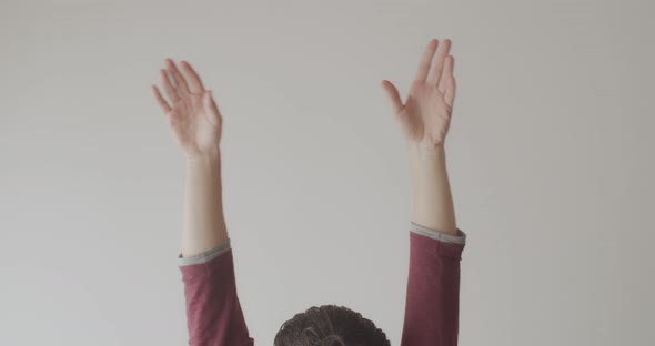 Male Hands Joined Together in Yoga Mudra Indoors on White Background Natural Light. Faceless Person