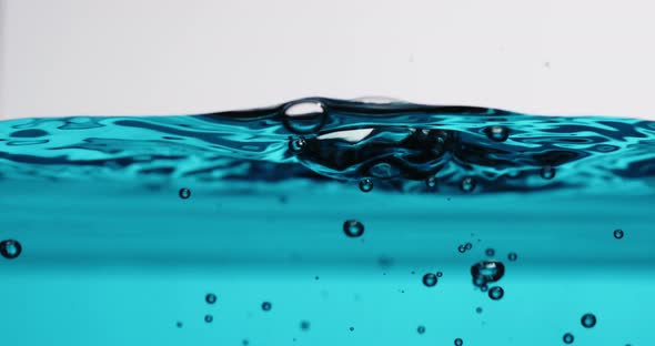 Surface Disturbed As Water Is Poured In With Splashes And Bubbles alt