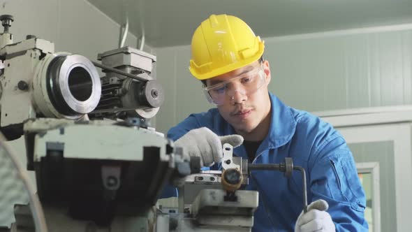 Asian mechanical technicians male workers working on milling and operating the machine in factory. alt