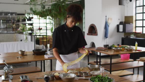 Diverse group of chefs preparing dishes and smiling in a kitchen alt