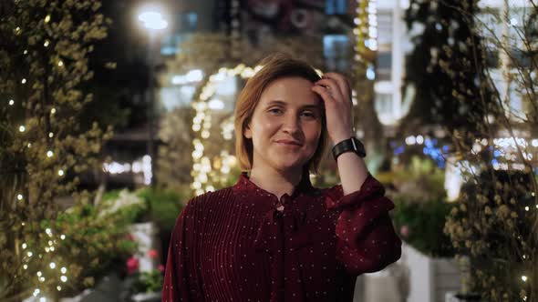 Portrait of small business owner in flower store. Young female florist in greenhouse. alt