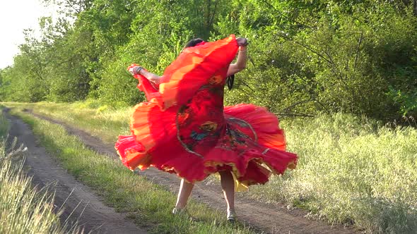 Gypsy girl in a field of poppies dancing in slow motion.