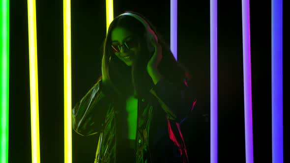 Portrait of a Pretty Young Beautiful Woman Listening To Music and Dancing with Big White Headphones alt