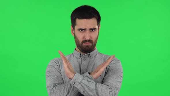 Portrait of Brunette Guy Strictly Gesturing with Hands Crossed Making X Shape Meaning Denial Saying alt