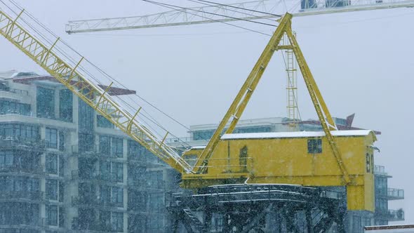 Crane Near Buildings In Heavy Snowfall alt