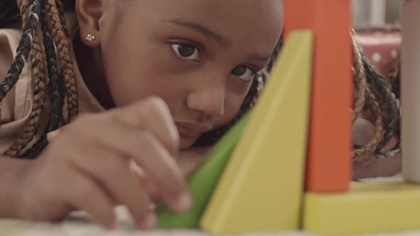 Cute Girl Playing with Building Toy alt