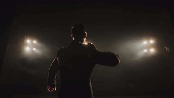 The Man is Coming on Stage and Raising Up the Microphone alt