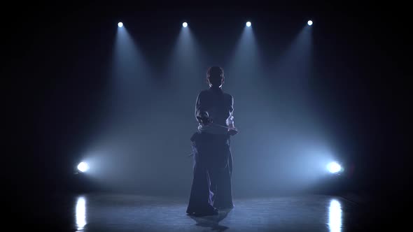 Aikido Master Technique Demonstration with Japanese Sword Katana. Silhouette on Black Studio alt