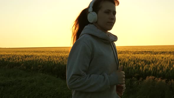 Healthy Beautiful Girl Doing Fitness Jogging on a Wheat Field. Training Run. Free Young Woman Runs alt
