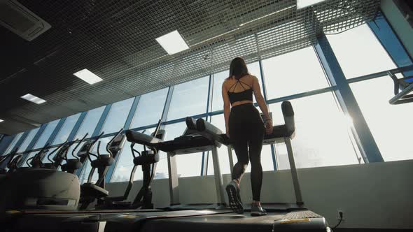 Fitness Woman Walking on Treadmill in Gym Having Cardio Training alt