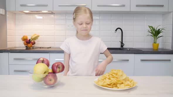 Girl Rejecting Chips in Favor of Apples