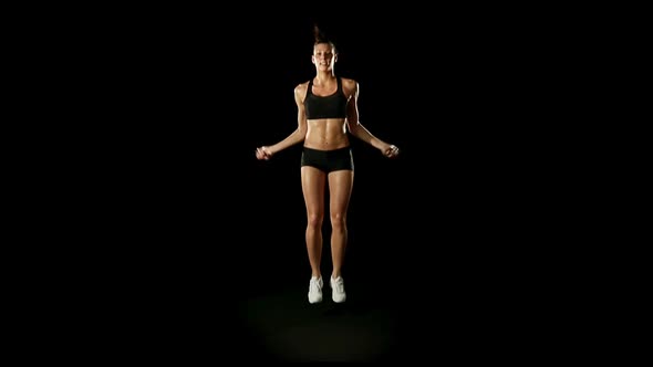 Young Athletic Woman Wearing Sporstwear is Exercising Slow Motion Isolated on Black Edit