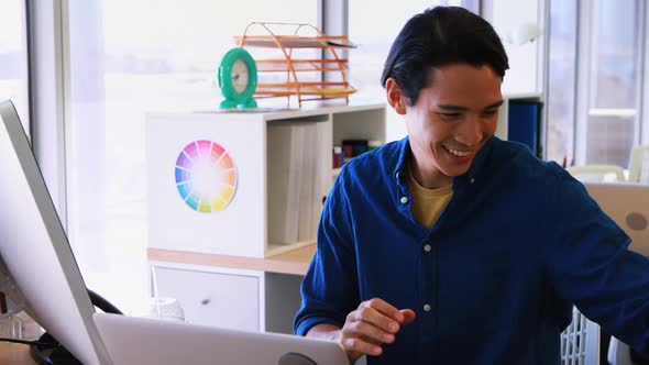 Male executive working over laptop at his desk 4k alt