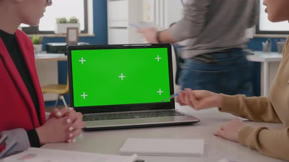 Close Up of Colleagues Using Laptop with Green Screen alt