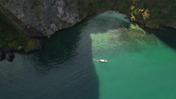 aerial top down view circling a thai longtail boat on a tour of the islands in Krabi Thailand on a s alt