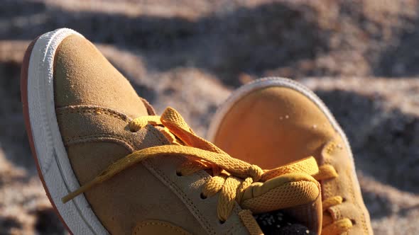 Close Up of Yellow Shoes on the Beach at the Sunset