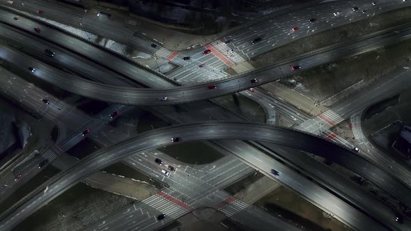 Aerial Flyover Traffic Jam Interchange Road at Night Drone Shot Top Down View Roadway Intersection alt