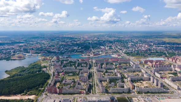 Flying drone over the over the city blocks and the embankment. Hyperlaps alt