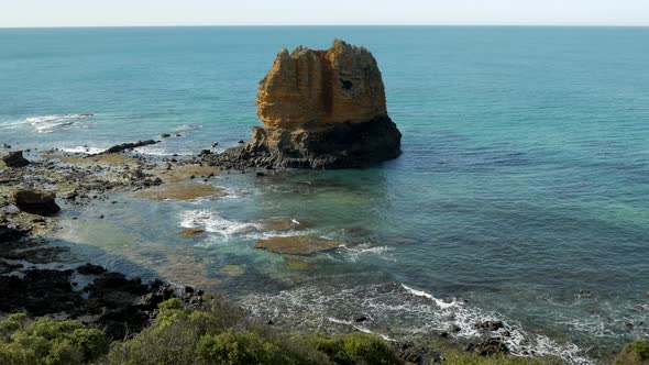 Large limestone rock stack located at an Australian coastal beach shot from a lookout. WIDE SHOT. TI alt