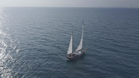 Sailboat navigating by the sea in the morning