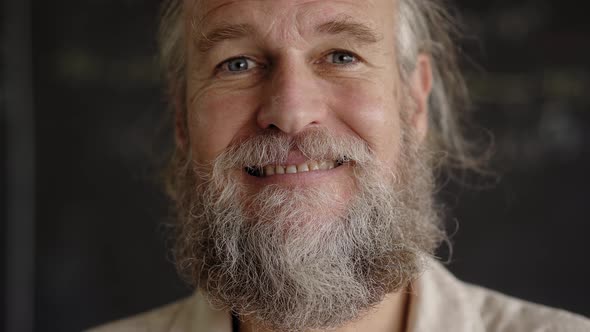 Portrait of Handsome Middle Aged Man Looking at Camera Smiling alt