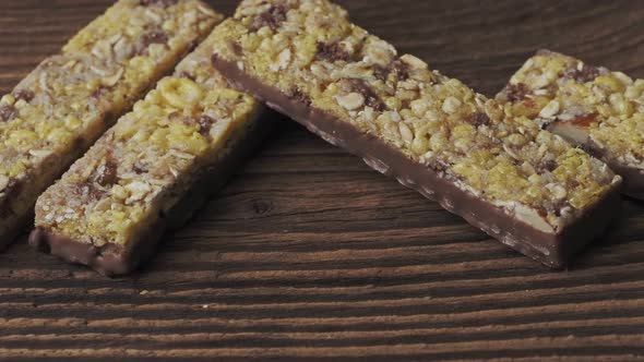 Chocolate muesli bars on old wooden table