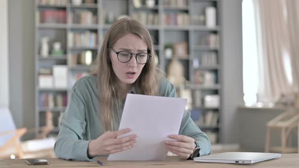 Portrait of Woman Getting Upset While Reading Documents in Office alt