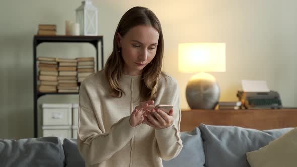 Woman Getting Good News Notification Via Mobile Phone alt