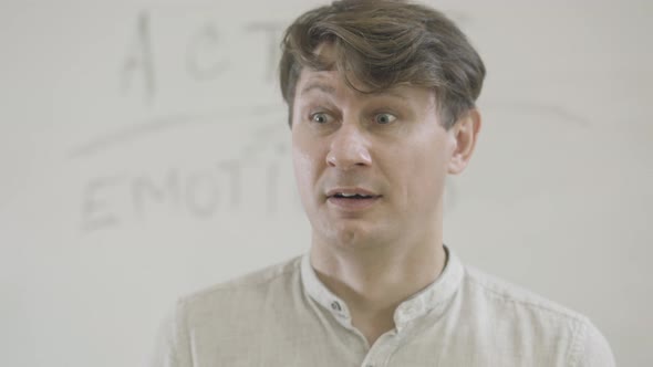 Closeup of Caucasian Actor Making Surprised Facial Expression and Laughing alt