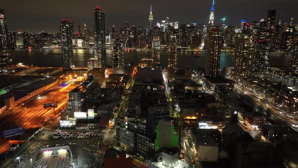 An aerial timelapse by the entrance of the Midtown Tunnel in Long Island City, New York at night. Th alt