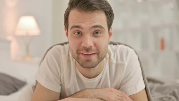 Close Up Young Man Doing Video Chat in Bed alt