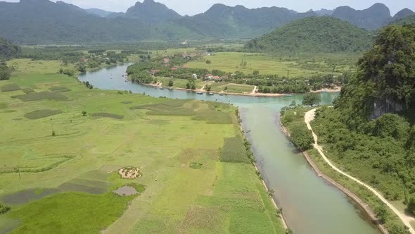 Tranquil River Runs Along Valley with Fields Aerial View alt