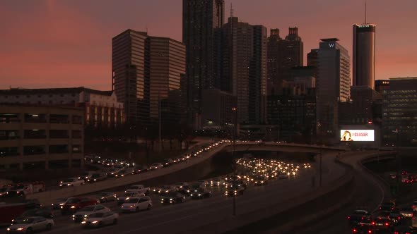 Static, medium wide, nighttime shot of the Atlanta Skyline with traffic below. alt