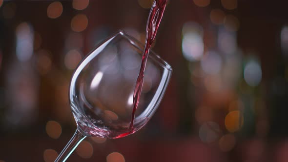 Red Wine Pouring Into Glass in Super Slow Motion alt