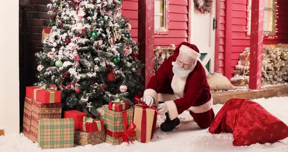 Santa Claus Puts Boxes of Gifts From Big Sack Under Christmas Tree on Christmas Eve or New Year Eve alt