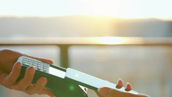 Closeup Woman Using Smartphone Cashless Wallet NFC Technology to Pay Order on Bank Terminal alt