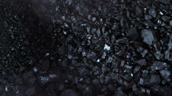 Super Slow Motion Shot of Crushing Coal on Black Background at 1000 Fps alt