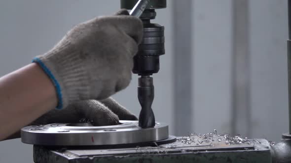 Chinese worker are working on machine tool  in factory alt