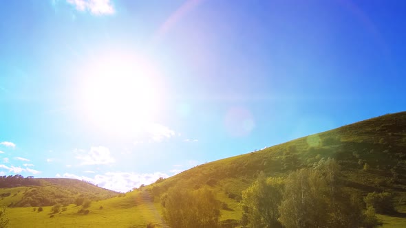  UHD Mountain Meadow Timelapse at the Summer. Clouds, Trees, Green Grass and Sun Rays Movement. alt
